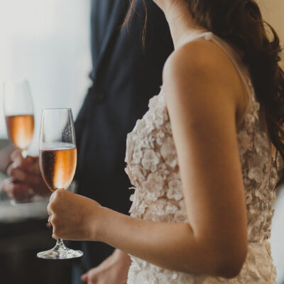 bride and groom holding wine glass