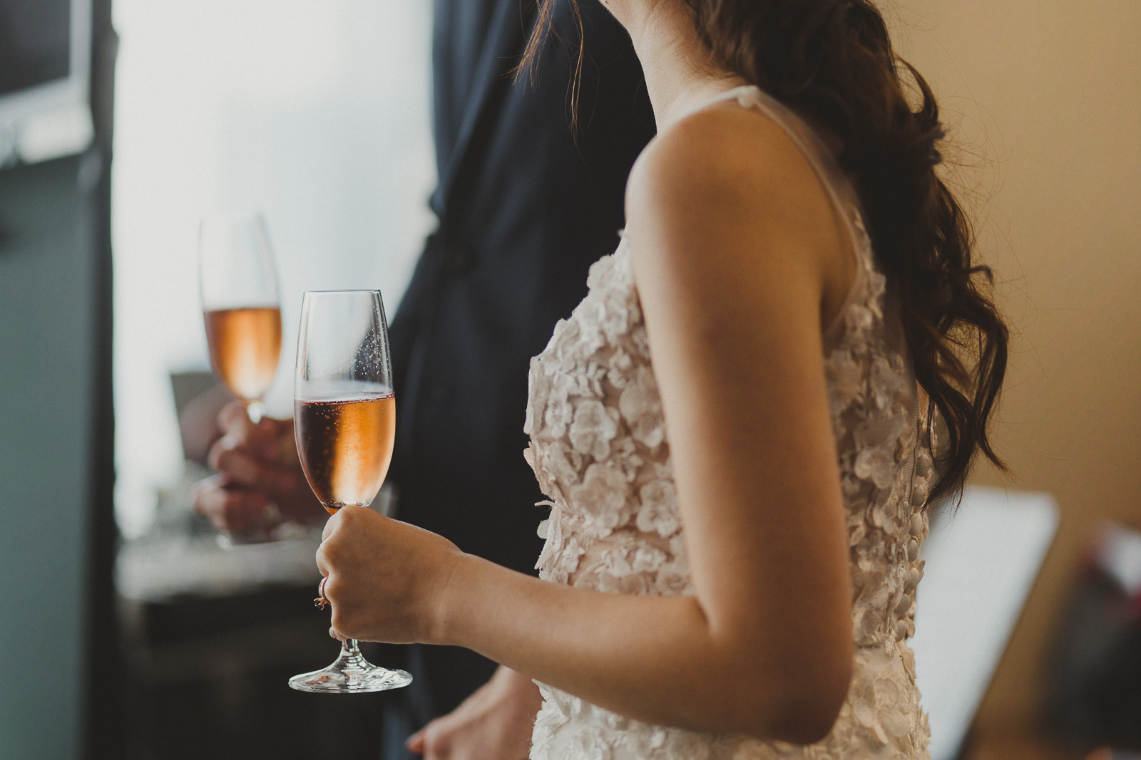 bride and groom holding wine glass